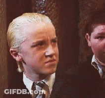 A Boy With Blonde Hair And A White Shirt And Tie GIF
