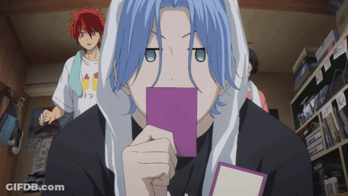 A Boy With Blue Hair Holds A Purple Card In Front Of His Face GIF