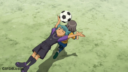 A Boy With Blue Hair Is Holding A Soccer Ball Over His Head GIF