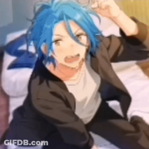 A Boy With Blue Hair Is Sitting On A Bed With His Hands In The Air . GIF