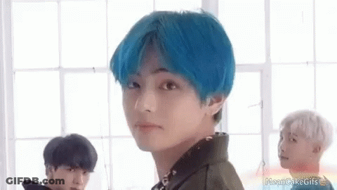 A Boy With Blue Hair Is Standing In Front Of A Window . GIF