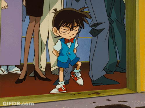 A Boy With Glasses And A Bow Tie Is Standing In A Crowd GIF