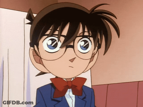 A Boy With Glasses And A Red Bow Tie Looks At The Camera GIF