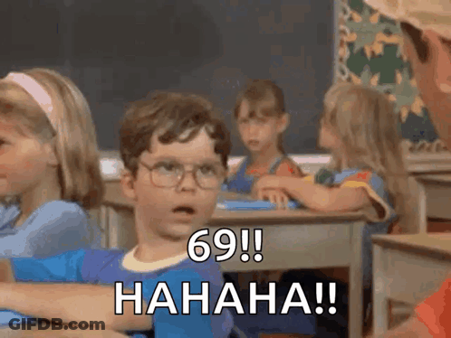 A Boy With Glasses Is Sitting At A Desk In A Classroom And Says 69 ! Hahaha !! GIF