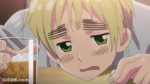 A Boy With Green Eyes Is Leaning On A Table With A Glass Of Beer In Front Of Him GIF