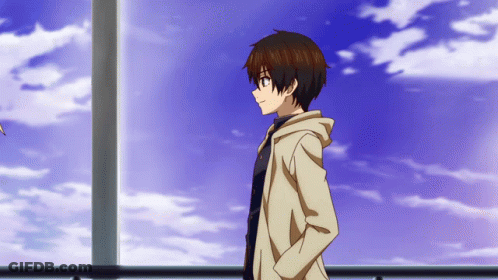 A Boy With His Hands In His Pockets Stands In Front Of A Cloudy Blue Sky GIF