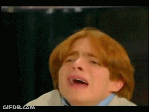 A Boy With Red Hair Is Crying With His Mouth Open GIF