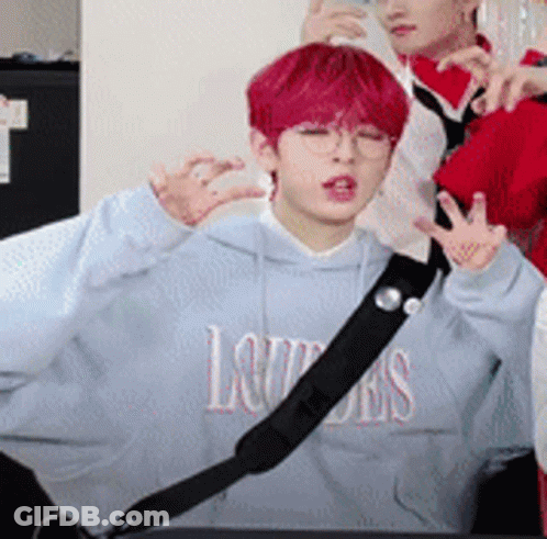 A Boy With Red Hair Is Wearing A Blue Hoodie That Says Louis On It . GIF