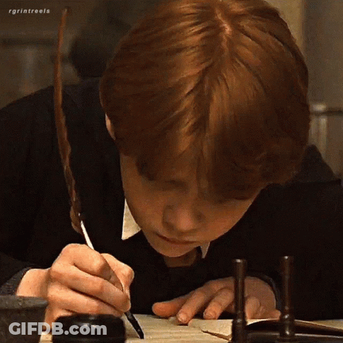 A Boy With Red Hair Is Writing On A Piece Of Paper With A Pen . GIF