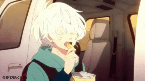 A Boy With White Hair Is Eating A Bag Of Potato Chips In A Car . GIF