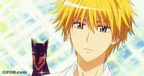 A Boy With Yellow Hair And Green Eyes Is Holding A Dog GIF