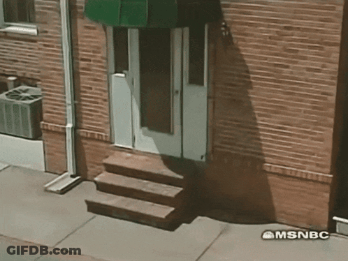 A Brick Building With Stairs And A Green Awning Says Msnbc GIF