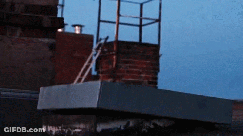 A Brick Chimney With A Ladder Going Up It GIF