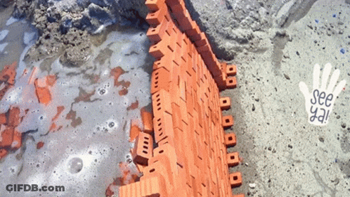 A Brick Wall Is Being Built With A Hand That Says See Ya GIF