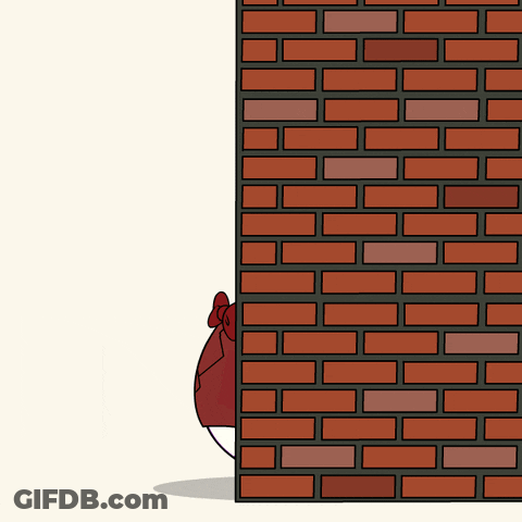 A Brick Wall With A Cartoon Character Peeking Out Of It GIF