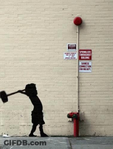 A Brick Wall With A Red Fire Hydrant And A Sign That Says Sprinklers Throughout Building GIF