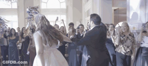 A Bride And Groom Are Dancing At Their Wedding Reception GIF