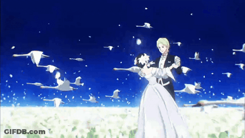 A Bride And Groom Are Dancing In Front Of A Flock Of Swans GIF