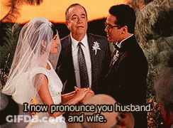 A Bride And Groom Are Getting Married And The Words I Now Pronounce You Husband And Wife Are Above Them GIF