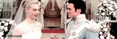 A Bride And Groom Are Holding Hands At Their Wedding And The Bride Is Talking To The Groom . GIF