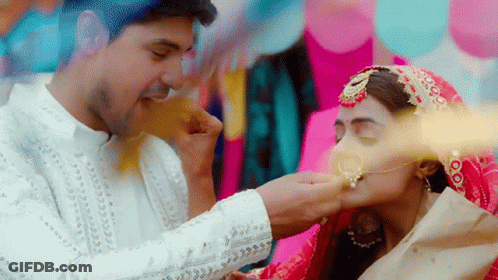 A Bride And Groom Are Kissing And The Bride Is Wearing A Nose Ring GIF
