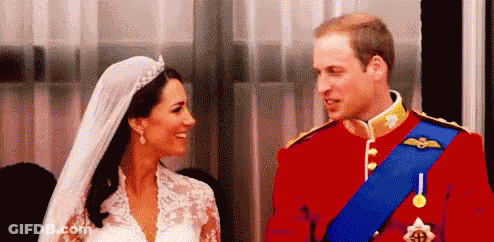 A Bride And Groom Are Looking At Each Other . GIF