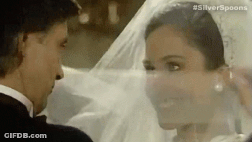 A Bride And Groom Are Looking Into Each Other 'S Eyes . GIF