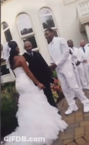 A Bride And Groom Are Posing For A Picture With Their Wedding Party GIF