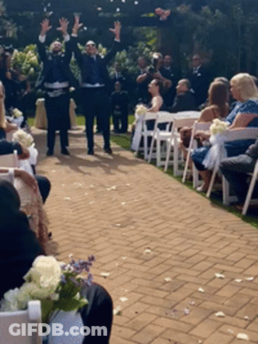A Bride And Groom Are Walking Down The Aisle At Their Wedding Ceremony GIF