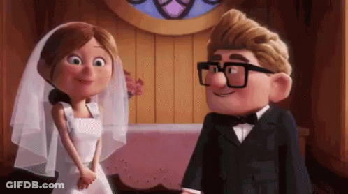 A Bride And Groom From Up Are Standing Next To Each Other And Smiling At Each Other . GIF