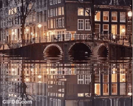 A Bridge Over A Body Of Water With A Reflection Of Buildings In The Water GIF