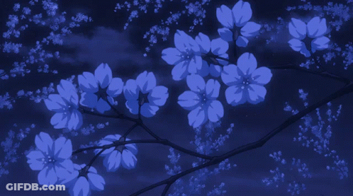 A Bridge With A Tree In The Foreground With Petals Falling From It GIF