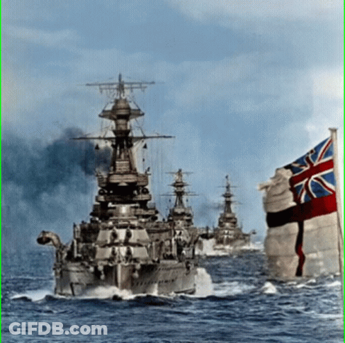 A British Flag Flies In Front Of A Row Of Ships GIF