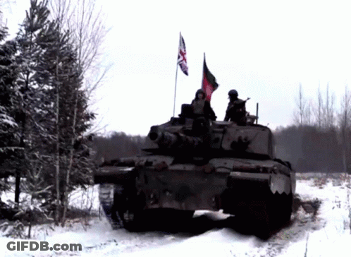 A British Flag Is Flying From The Top Of A Military Vehicle GIF