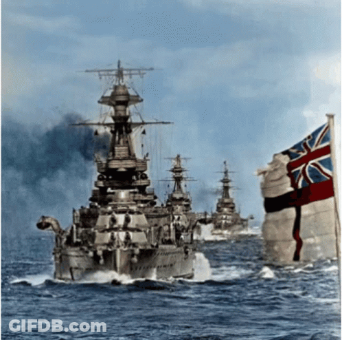 A British Flag Is Flying In Front Of A Group Of Ships GIF