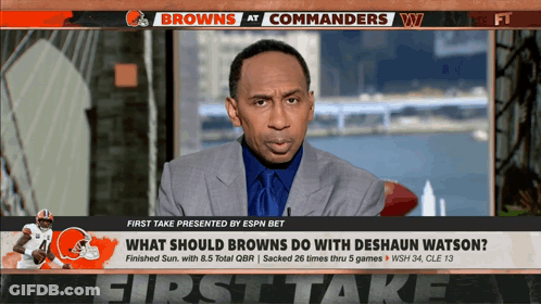 A Broadcast Of The Browns At Commanders With A Man In A Suit On The Screen GIF