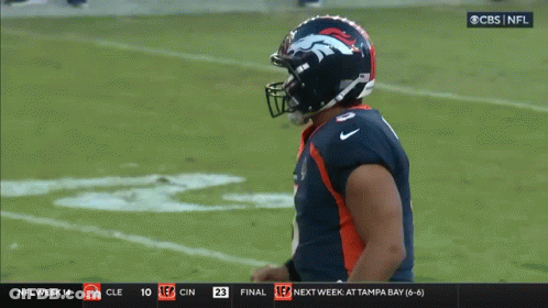 A Broncos Football Player Celebrates On The Field During A Game GIF