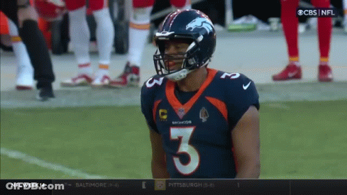 A Broncos Player Wearing Number 3 Stands On The Field GIF