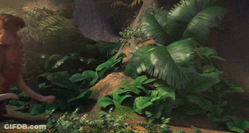 A Brown Elephant With A Large Tusks Is Standing In A Jungle GIF