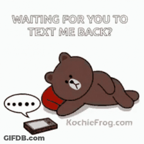 A Brown Teddy Bear Is Laying On A Pillow Next To A Cell Phone With The Words Waiting For You To Text Me Back GIF