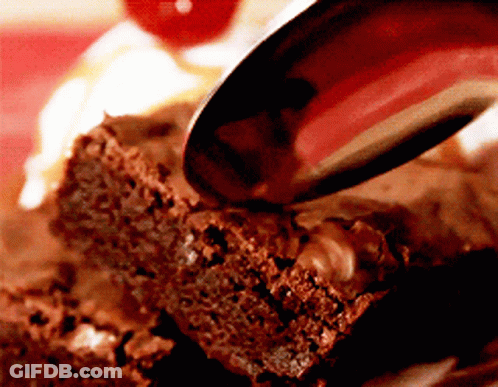 A Brownie Is Being Eaten With A Spoon And A Cherry In The Background GIF