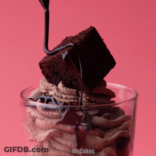 A Brownie Is Being Poured Into A Glass With The Words Mr.cakes Written On The Bottom GIF