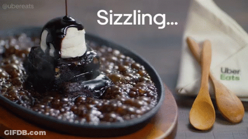 A Brownie With A Scoop Of Ice Cream On Top And The Words Sizzling Written Above It GIF