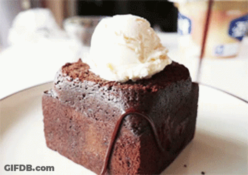 A Brownie With A Scoop Of Ice Cream On Top Of It GIF