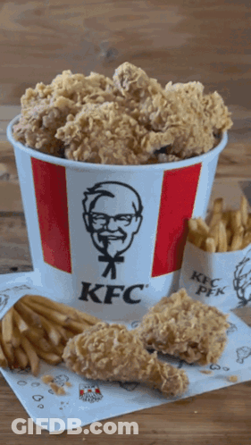 A Bucket Of Kfc Fried Chicken And French Fries On A Table GIF