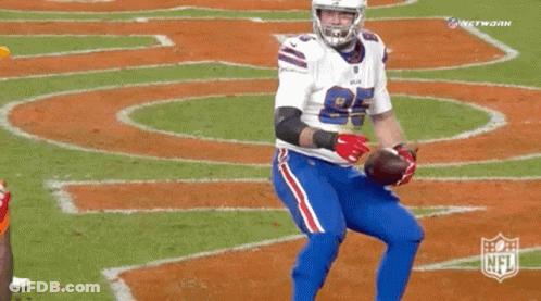 A Buffalo Bills Football Player Holds A Football In His Hands GIF
