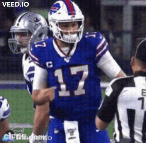 A Buffalo Bills Football Player Is Pointing At A Referee During A Football Game . GIF