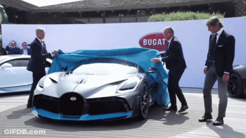A Bugatti Car Is Covered With A Blue Tarp GIF