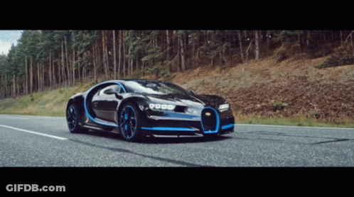A Bugatti Chiron Is Driving Down A Road In The Woods GIF