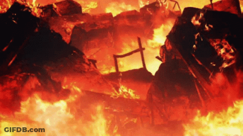 A Building Is On Fire With A Cross In The Middle Of It GIF